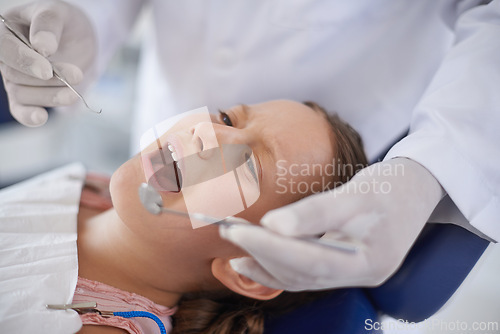 Image of Crying, child and hands with tools for dental, gum disease and oral hygiene mouth inspection with fear. Dentist, orthodontics and consultation for teeth health, cleaning and wellness with excavator