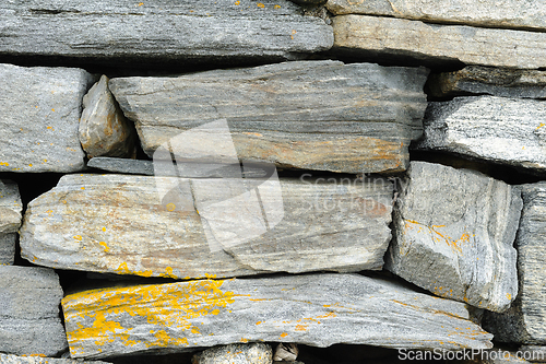 Image of Close-up view of a dry stone wall displaying various textures an