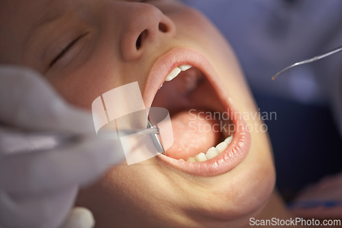 Image of Teeth, child and dentist with tools in mouth for gum disease and oral hygiene with dental inspection. Medical, orthodontics and patient consultation for health, cleaning and wellness with instruments