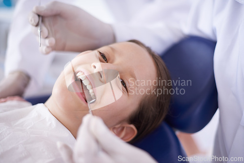 Image of Girl, child and hands with tools for dental, gum disease and oral hygiene with mouth inspection and face. Medical, orthodontics and consultation for teeth health, happiness or wellness with excavator