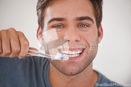 Image of Face, man brushing teeth and toothbrush for dental and wellness, fresh breathe and tooth whitening in morning routine. Clean mouth, toothpaste and oral care with orthodontics and hygiene in portrait