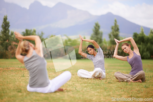 Image of Woman, personal trainer and yoga class on field in nature for spiritual wellness, namaste or wellbeing. Young female person, yogi or fitness teacher with group in zen or balance for outdoor exercise