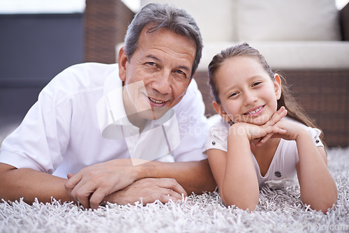 Image of Happy, portrait and grandpa with girl in home on holiday or vacation together in retirement with smile. Senior, man and grandparent relax with child on floor in living room and bonding in Mexico