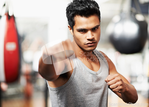 Image of Man, portrait and training with confidence, boxing and fists ready to punch in match for health and exercise. Male person, workout and focus in gym, mma and boxer for sports and combat for defence