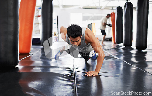 Image of Man, pushups and training for fitness, sport and health for being a boxer on mat with one arm. Male person, wellness and exercise for workout, athlete and cardio strength for commitment in boxing gym
