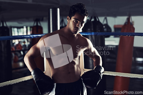 Image of Male person, boxing and sport in gym, portrait and fitness for exercise and wellness in training for strong fight. Man, athlete and boxer in workout, challenge and shirtless ready to punch for mma