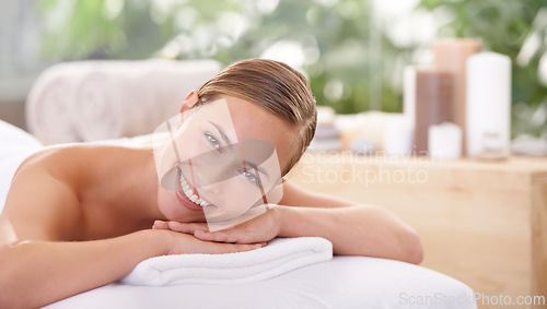 Image of Woman, spa and smile for wellness, health and self care for relaxation and portrait and therapy. Female person, luxury resort and body treatment for serenity skincare and massage table to destress