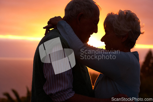 Image of Sunset, elderly couple and hug outdoor, love and bonding for connection together in nature. Man, woman and embrace for care, romance and support for commitment to relationship in retirement on date