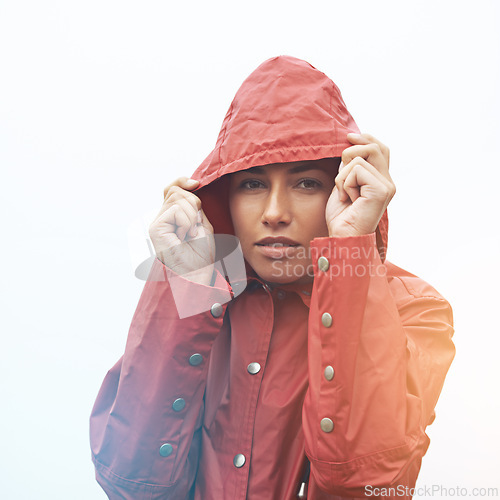 Image of Woman, portrait and raincoat with hood for weather, cloudy sky or winter season in outdoor storm. Face of female person or model with red waterproof rain jacket for cold overcast or fog on mockup