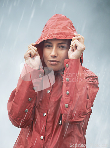 Image of Woman, rain and portrait with storm, raincoat and safety with protection in nature. Person, face and weather with cloudy, winter and waterproof hat for confidence with adventure or cold vacation