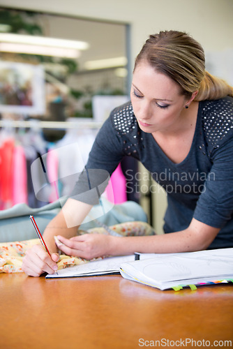 Image of Fashion, designer and drawing for style, design and creativity at desk in boutique with mockup. Creative, female person or clothes with fashionable, sketch and fabric with artistic inspiration