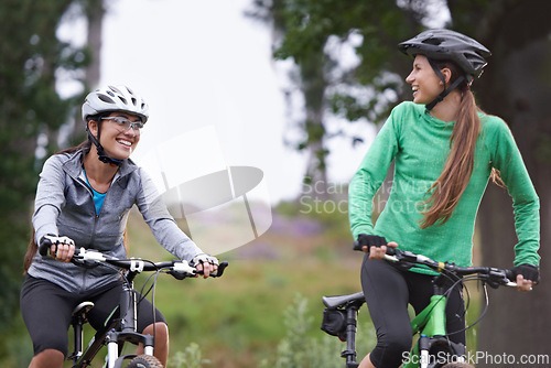 Image of Happy woman, friends and forest with bicycle on field for outdoor cycling, workout or cardio exercise in nature. Female person, athlete or cyclist with smile in fitness for off road training on trail