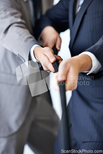 Image of Hands, effort and tug of war with businessmen in studio for collaboration or competition. Teamwork, partnership and challenge with corporate people pulling rope together for strength or struggle