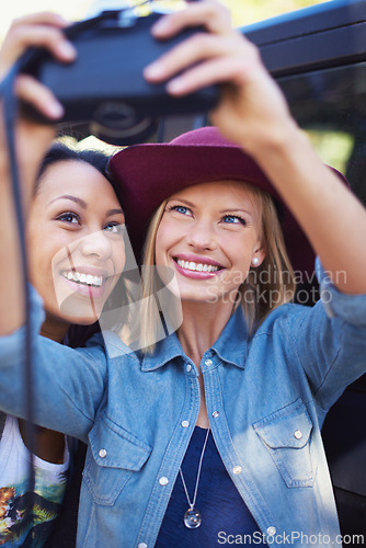 Image of Women, friends and selfie photo with a camera on a holiday outside for a road trip. Photography, friendship and female people smiling for fun vacation on a picture break outdoors with fashion