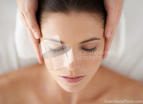 Image of Hands, above and facial massage of woman at spa to relax, peace and calm at luxury resort with masseuse. Top view, therapy and person at salon for face treatment, skincare and beauty for wellness