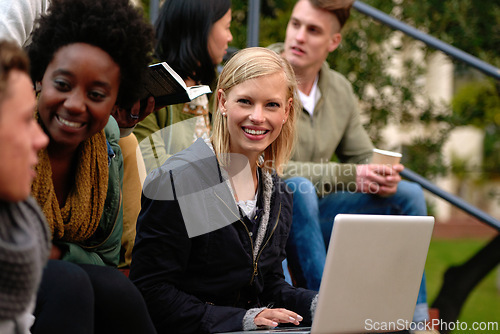 Image of Woman, university student with laptop and outdoor on campus, smile and research to study for exams. Diverse group, college and information for learning and share notes for test or assignment deadline