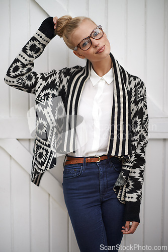 Image of Portrait, woman and fashion with casual style and hair in a bun. Female person with a smile and trendy clothes while happy and confident for creative career with glasses as a young professional