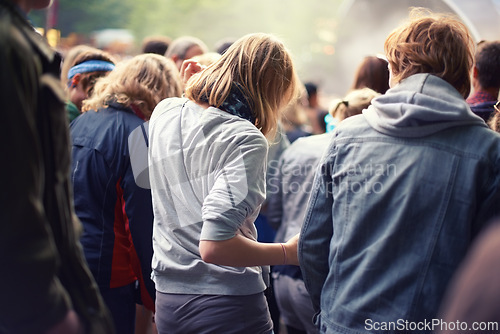 Image of Woman, crowd and dance at concert in summer for event, festival and entertainment outdoors. Community, celebration and friends at party with audience for sound, energy and live music in nature