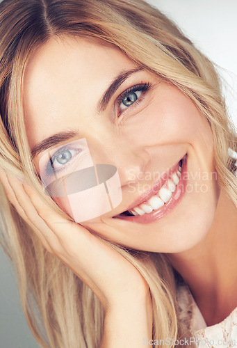 Image of Closeup, makeup and portrait of woman with smile for cosmetic, beauty and healthy skin for wellness. Happy, face and female person with hand for relaxing with skincare, dermatology or self care