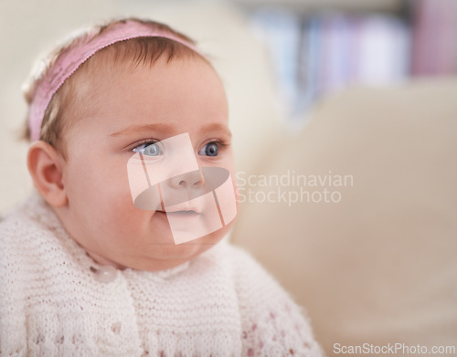 Image of Happy, baby and face in a home with a calm, relax and sweet infant in a living room. Youth, child and house with toddler clothing in the morning ready for a nap on the sofa with joy and headband