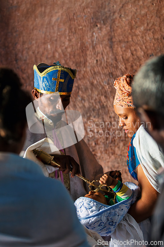 Image of Orthodox Christian baptism ceremony at St. George Church captures a sacred moment in Ethiopian spiritual life.