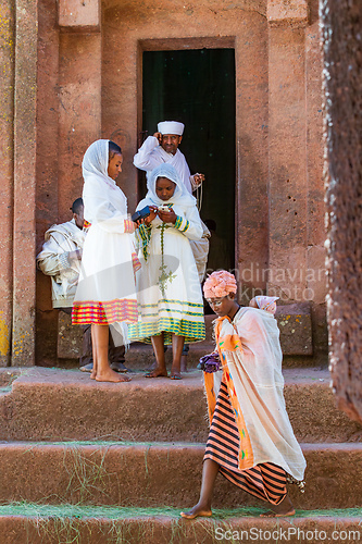 Image of Orthodox christian Ethiopian people behind famous rock-hewn church, Lalibela Ethiopia people diversity,