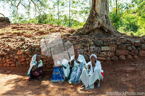 Image of Orthodox christian Ethiopian people behind famous rock-hewn church, Lalibela Ethiopia people diversity,