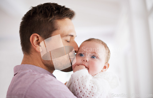 Image of Love, father and baby with kiss in home for affection, comfort and bonding together for healthy development. Family, man and newborn child with hug, embrace and relax for parenting, care and security