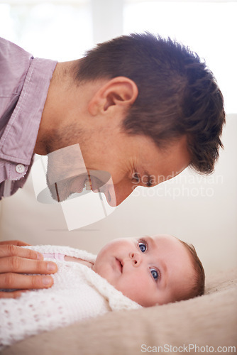 Image of Father, playing and newborn baby on bed with love, support and care for family, paternity and bonding. Excited dad, man or parent with his child or kid for development, growth and nurture at home