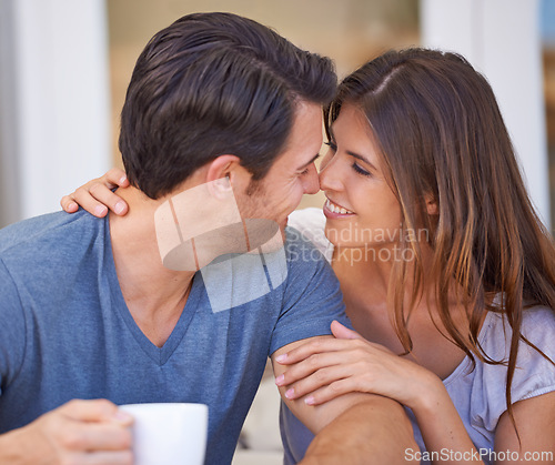 Image of Happy couple, coffee and love with romance for morning or affection together at home. Face of young man and woman with smile, cup of tea or cappuccino for intimacy, support or care in trust at house