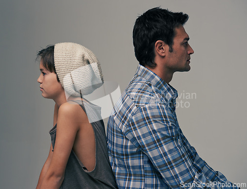 Image of Father, son and back in disagreement, argument or ignore with fashion on a gray studio background. Profile of dad, kid or young child in casual clothing, conflict or fight for parenthood or childhood