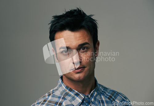 Image of Serious, fashion and portrait of man in studio with confidence, pride and attitude. Mockup space, model and face of isolated person with trendy clothes, casual outfit and style on gray background