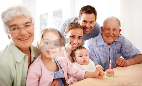 Image of Family, portrait and birthday party, cupcake and candle to celebrate and happy people at home. Parents, grandparents and children with cake or dessert for anniversary and generations with smile