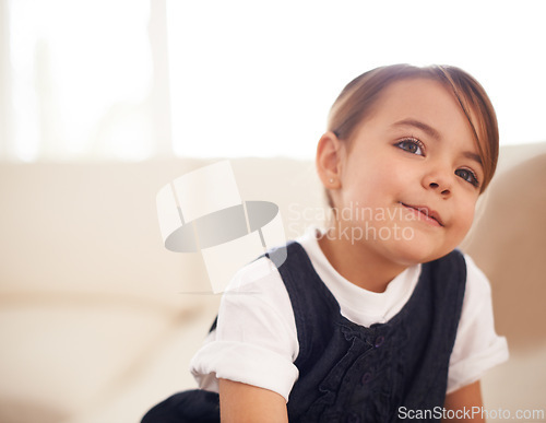 Image of Girl kid, thinking or dream of future at home with questions, pensive and contemplating in living room. Thoughtful, mindfulness and ideas with youth, decision or choice for imagination and fantasy