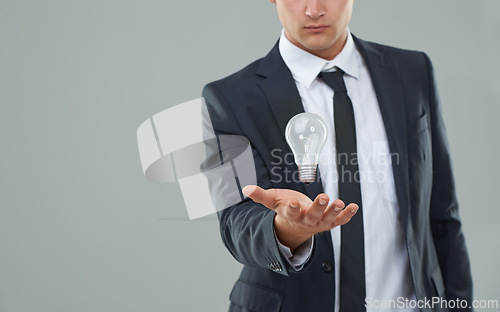 Image of Business man, light bulb and ideas for company, entrepreneur with innovation and problem solving for energy saving. Hologram, solution and corporate goals for knowledge and power on grey background