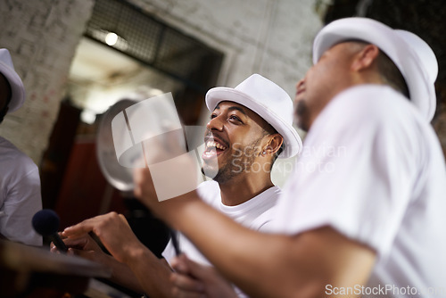 Image of Excited man, band and percussion with music at night for performance, singing or musical event. Happy person or group of musicians playing instruments for sound or fun local entertainment at concert