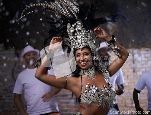 Image of Night, woman and dancer with band at carnival in rio de janeiro for brazilian festival with feather costume or smile. Person, face and happy with samba, fashion and music for culture or outdoor event