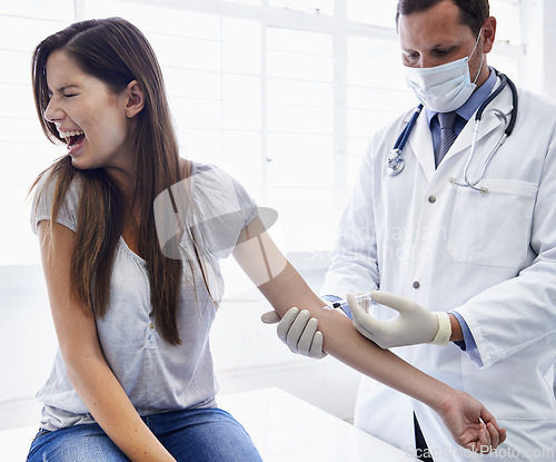 Image of Doctor, woman and arm injection or scared scream in hospital or anxiety feaR or medicine treatment, disease or diagnosis. Male person, face mask and patient with needle panic, terror or trypanophobia