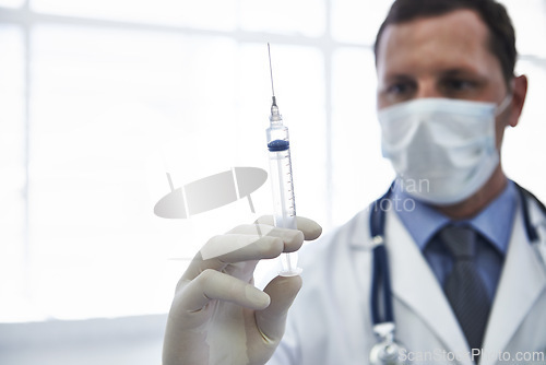 Image of Doctor, syringe and vaccine injection with needle for disease treatment for influenza virus, antibiotic or healthcare. Male person, face mask and immunization shot in hospital, booster or prevention