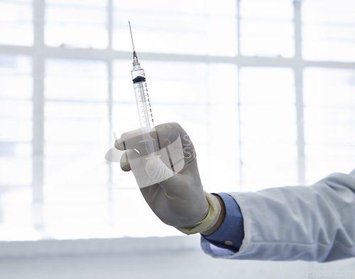 Image of Doctor, hand and syringe or vaccine injection or influenza virus treatment for prevention, booster or flu shot. Person, fingers and gloves as immunization vial or antibiotic, medication or allergy