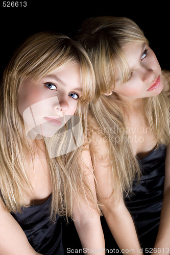 Image of Young blonde and her reflection in a mirror