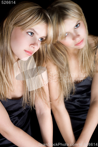 Image of Portrait of the young blonde near a mirror