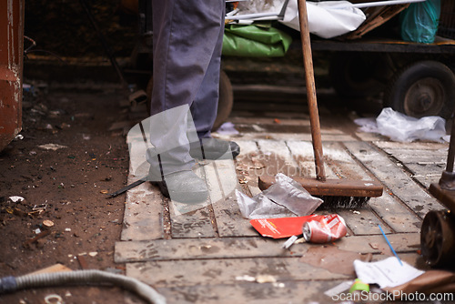 Image of Legs, broom and sweeping dirt on floor, hygiene and cleaning for sanitation in dirty outdoors. Feet, street cleaner and equipment for mess in town, pollution and person for protection of bacteria