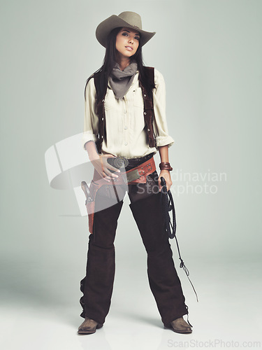 Image of Woman, cowgirl and outfit in studio, portrait and costume for western casting with rope or whip. Female person, cowboy hat and clothes from Texas, white background and dress up for audition or ad