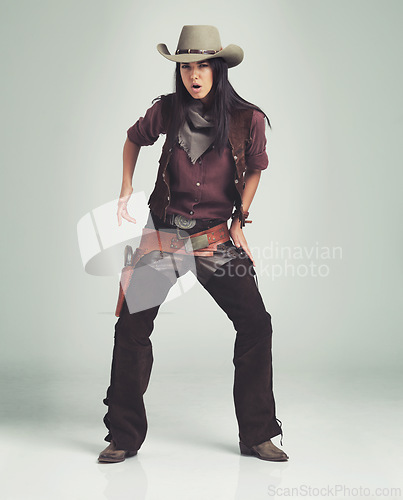 Image of Woman, cowgirl and portrait in studio with weapon or western costume on white background, revolver or outlaw. Female person, wild and hat with mockup space in Texas for dress up, outfit or accessory