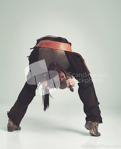 Image of Cowgirl, portrait and woman with costume, gun and power with Halloween and firearm on a white studio background. Person, mockup space and Texas with model, Western outfit and girl with danger