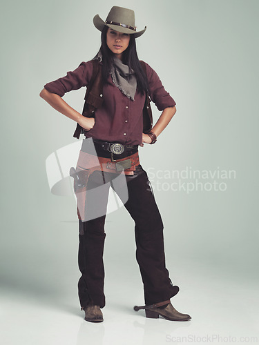 Image of Woman, fashion and cowboy clothes with portrait in studio, western character and costume on white background. Wild west style, outlaw cosplay and vintage apparel with confidence and aesthetic