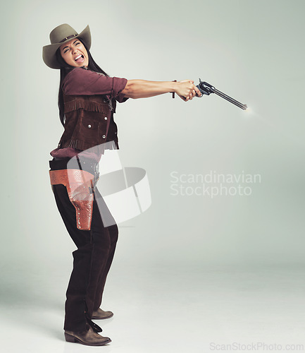 Image of Cowgirl, woman and shooting gun, weapon or pistol in studio with costume isolated on white background mockup. Western, criminal and female person with revolver, scared or screaming in fear in Texas