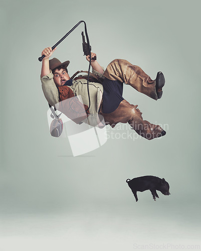 Image of Cowboy, accident and man catching pig for texas culture in studio on gray background with space. Western, animal or noose and clumsy young person in costume with fail, mistake or oops for falling