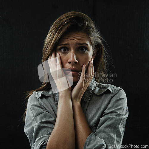 Image of Portrait, stress and horror with phobia woman in studio on black background for reaction to fear. Face, anxiety and mental health with scared young person in dark for drama, nightmare or terror